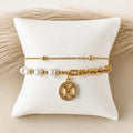 Pulsera doble con dije y perlas